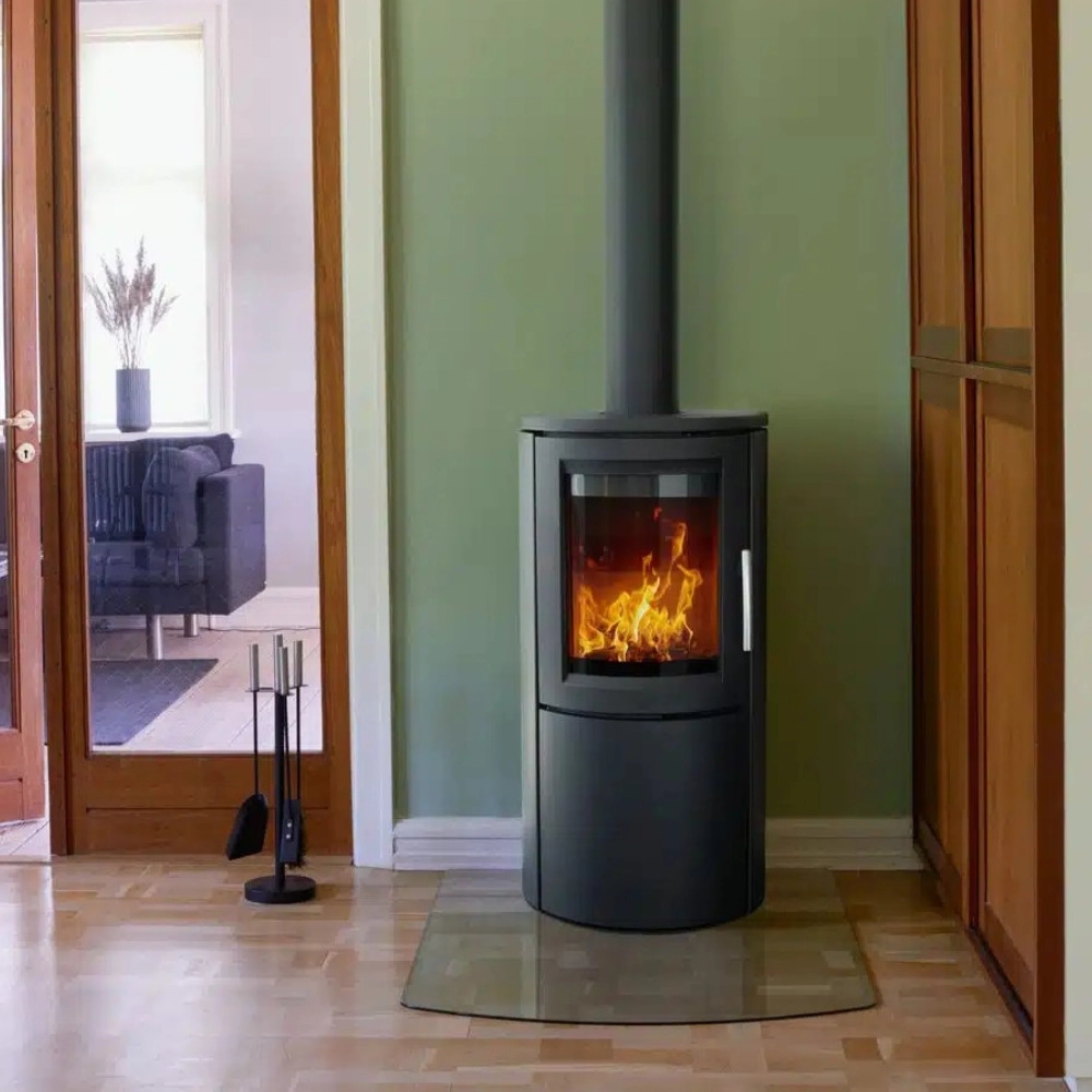 Modern black wood burning stove with twin wall flue in a home interior
