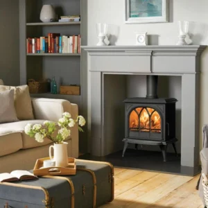 Traditional black wood burning stove installed inside a living room fireplace