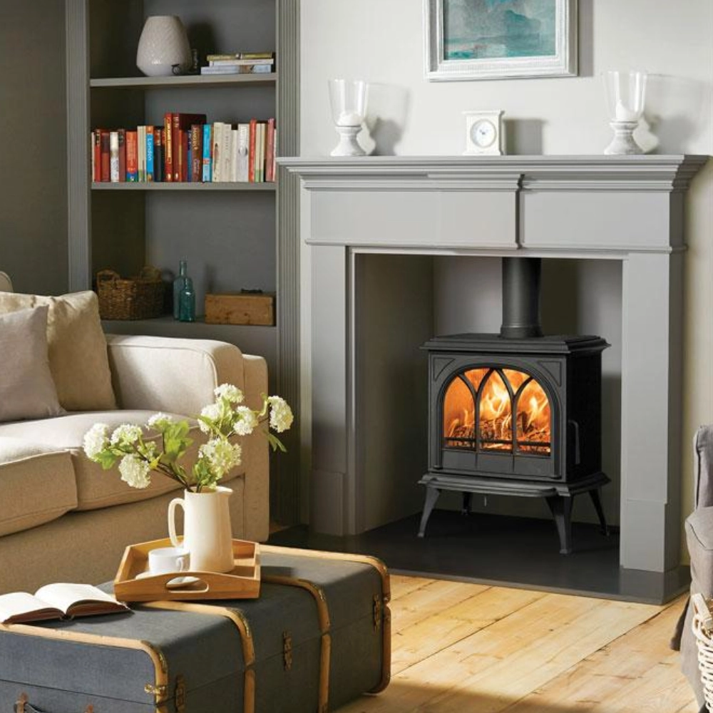 Traditional black wood burning stove installed inside a living room fireplace